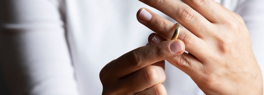Woman pulling ring off of finger