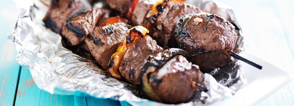 Lean grilled kebabs at a summer cookout offer a healthy high protein option