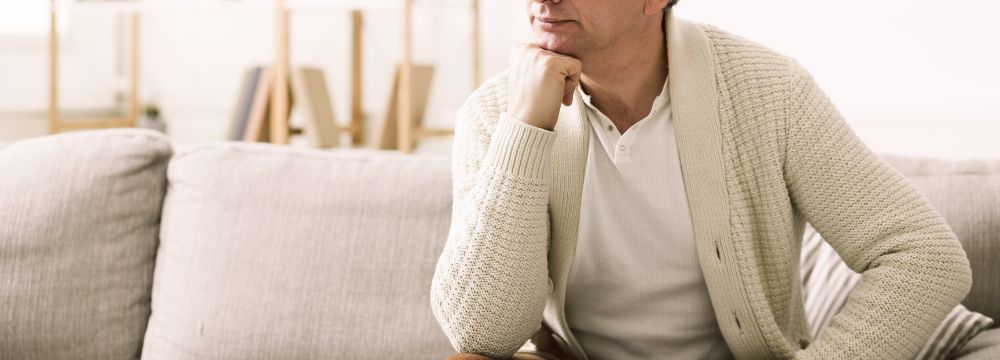 Man pondering wether a doctors visit is necessary for his hernia symptoms