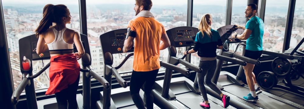 our people running on treadmills facing window