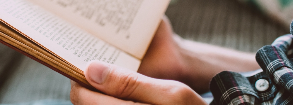 Man holding a book practicing me time